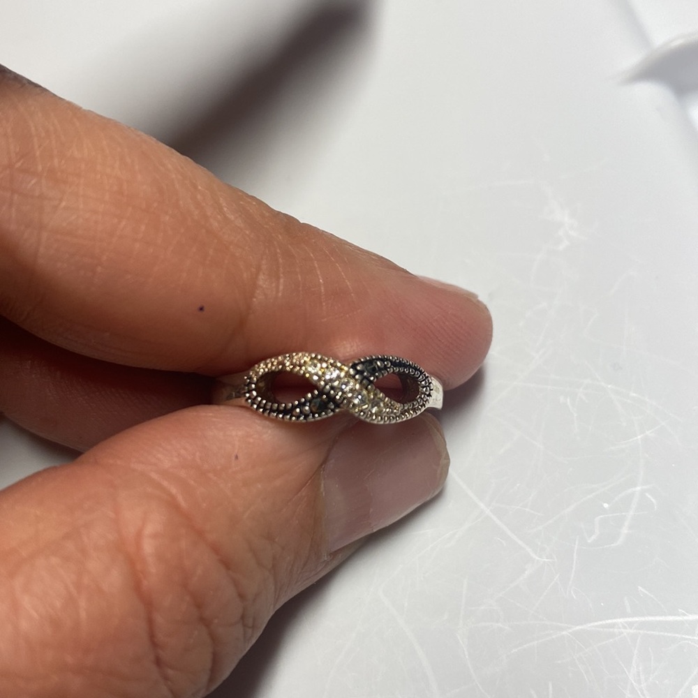 Sterling marcasite ring featuring sparkling infinity loop design. Size 6